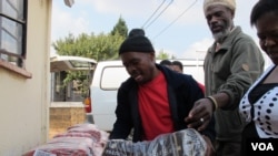 Local Spaza owners distribute products they bought in bulk in Dube Village, Soweto, South Africa (Photo: Gillian Parker for VOA)