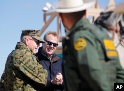 Acting Secretary of Defense Patrick Shanahan, center, and Joint Chiefs Chairman Gen. Joseph Dunford, left, meet with Border Patrol Agents during a tour of the U.S.-Mexico border at Santa Teresa Station in Sunland Park, N.M., Feb. 23, 2019.