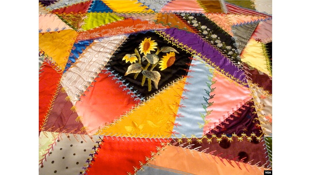 Quilts assembled from small, irregular pieces of fabric are called "Crazy" quilts. This one, by Mary Stinson, was created around 1880. (J. Taboh/VOA)