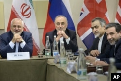 Iranian Foreign Minister Javad Zarif, left, Head of Iranian Atomic Energy Organization Ali Akbar Salehi, second left, Special Assistant to Iranian president Hossein Fereydoun, second right, and Iranian Deputy Foreign Minister Abbas Araghchi wait for the s