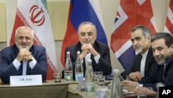 Menteri Luar Negeri Iran Javad Zarif (kiri) bersama para pejabat terkait dari Iran menunggu dimulainya pembicaraan mengenai program nuklir di Lausanne, Swiss (30/3). (AP/Brendan Smialowski)