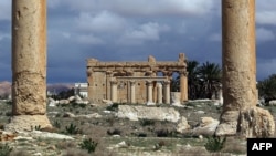 FILE - Temple of Baal Shamin seen through two Corinthian columns in the ancient oasis city of Palmyra, Syria.