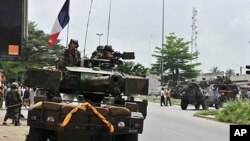 French soldiers from Operation Licorne in the Ivory Coast patrol in the 'Deux Plateaux' district of Abidjan, April 9, 2011