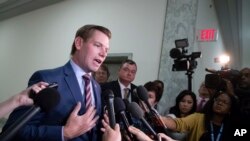 FILE - Rep. Eric Swalwell, D-Calif., pauses to speak with reporters on Capitol Hill in Washington, July 16, 2018.