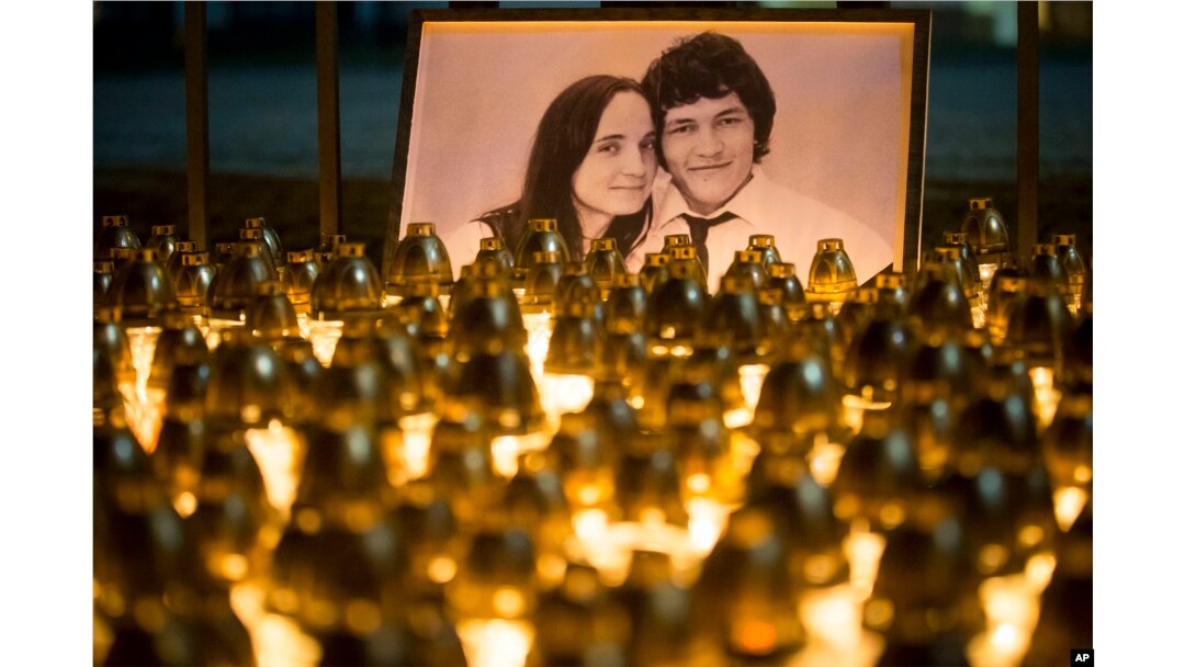 Light tributes are placed during a silent protest in memory of slain journalist Jan Kuciak and his girlfriend, Martina Kusnirova, seen in the photograph, in Bratislava, Slovakia, Feb. 28, 2018.