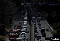 FILE - Vehicles sit in traffic on the main highway leading to San Jose, Costa Rica, Jan. 30, 2018.