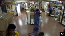 FILE - A man carries boxes at the Page shopping center in Ciudad del Este, Paraguay, Nov. 30, 2001. Police raided an electronics store in this shopping center, seizing documents and other material that officials said promoted Hezbollah, Lebanon's Islamic militant party.