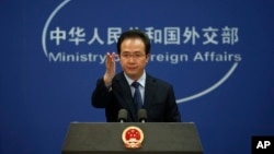 China's Foreign Ministry spokesman Hong Lei gestures during a daily briefing at the Ministry of Foreign Affairs office in Beijing, April 5, 2016. 