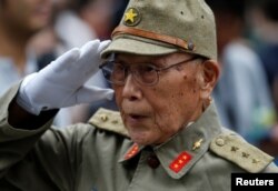 A man dressed as a Japanese imperial army soldier stands at Yasukuni Shrine in Tokyo, Japan, Aug. 15, 2017, to mark the 72nd anniversary of Japan's surrender in World War II.