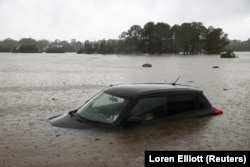 Sebuah mobil yang sebagian terendam terlihat ketika negara bagian New South Wales mengalami banjir, di Sydney, Australia, 22 Maret 2021. (Foto: REUTERS/Loren Elliott)