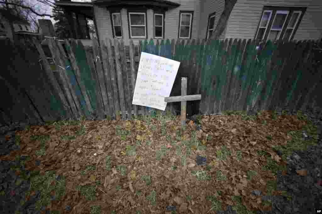 A sign and cross are displayed near where a Dec. 30, 2014 police stop resulted in the fatal shooting of Jerame Reid in Bridgeton, N.J., Jan. 21, 2015.