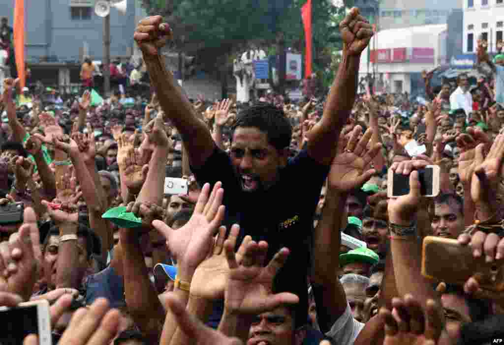 Supporters of Sri Lanka's ousted prime minister Ranil Wickremesinghe cheer at a rally in Colombo.