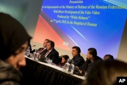 FILE - Syrians brought to The Hague by Russia in a move to discredit reports of an April 7, 2018, chemical weapons attack in the Syrian town of Douma appear at a press conference in The Hague, Netherlands, April 26, 2018.