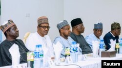 Nigeria's President Muhammadu Buhari sits with Plateau State governor Simon Lalong and officials during his visit to Plateau State, Nigeria in this handout picture released on June 26, 2018. (Nigeria Presidency/Handout via Reuters) 