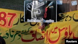 A journalist takes part in a demonstration in front of the Parliament building in Islamabad to protest a spate of killings of journalists, Jan. 28, 2013. 