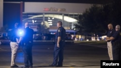 Officials stand by the scene outside the movie theater where a man opened fire on film-goers in Lafayette, Louisiana, July 23, 2015. 