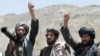 FILE - Taliban fighters react to a speech by their senior leader in the Shindand district of Herat province, Afghanistan. 