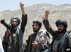 FILE - Taliban fighters react to a speech by their senior leader in the Shindand district of Herat province, Afghanistan, May 27, 2016.