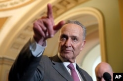 FILE - Senate Minority Leader Chuck Schumer of N.Y., points to a question during a media availability after a policy luncheon on Capitol Hill, May 8, 2018 in Washington.