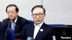 FILE - Former South Korean President Lee Myung-Bak appears for his first trial at the Seoul Central District Court, May 23, 2018, in Seoul, South Korea.