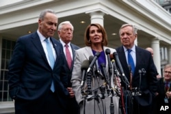 Speaker of the House Nancy Pelosi, flanked by Democratic colleagues, speaks to reporters after meeting with President Donald Trump about border security at the White House, Jan. 4, 2019.
