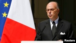 FILE - French Interior Minister Bernard Cazeneuve, shown at a Paris news conference in August, notes that "there are also Muslims and other minorities who are persecuted with the same degree of barbarity" as Christians.