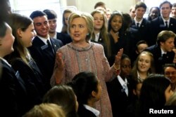 Democratic presidential candidate Hillary Clinton speaks with US Senate pages as she departs after meeting with Senate Democrats during their luncheon gathering at the U.S. Capitol in Washington, July 14, 2016.