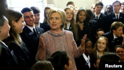 Democratic presidential candidate Hillary Clinton speaks with US Senate pages as she departs after meeting with Senate Democrats during their luncheon gathering at the U.S. Capitol in Washington, July 14, 2016. 