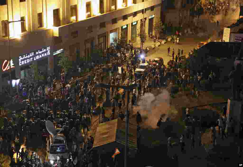 Lebanese riot police use tear gas during a protest against the ongoing trash crisis, in downtown Beirut, Aug. 22, 2015.