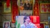 FILE - A television shows a broadcast of a Chinese talk show program as it sits beneath a photo of Chinese President Xi Jinping in a home converted into a tourist homestay in Zhaxigang village in western China's Tibet Autonomous Region, June 4, 2021.