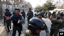 FILE - Security forces inspect the site of an Islamic State-claimed attack on a hospital in Kabul, Afghanistan, March 8, 2017.