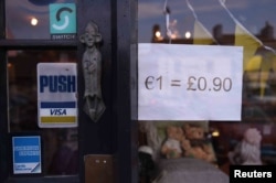 A shop indicating it's euro and sterling currency exchange rate is seen in the border town of Belleek, Northern Ireland, Oct. 14, 2016.