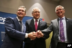 Canada's Minister of International Trade Francois-Philippe Champagne, Chile's Foreign Minister Heraldo Munoz and New Zealand's Trade Minister David Parker, pose for a photographers before a signing ceremony of the Comprehensive and Progressive Agreement for Trans-Pacific Partnership (CPTPP).