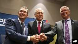 Canada's Minister of International Trade Francois-Philippe Champagne, Chile's Foreign Minister Heraldo Munoz and New Zealand's Trade Minister David Parker, pose for a photographers before a signing ceremony of the Comprehensive and Progressive Agreement for Trans-Pacific Partnership.