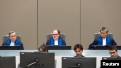 Judge Cuno Tarfusser (C), judge Chang-ho Chung (R) and judge Marc Perrin de Brichambautat (L) issue a ruling on South Africa's failure to arrest Omar al-Bashir, during a session of the ICC in The Hague, July 6, 2017.
