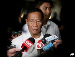 FILE - Philippine Vice President and an opposition presidential candidate Jejomar Binay talks to the media following his forum with the business sector, Oct. 7, 2015 at the financial district of Makati city, east of Manila.