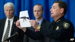 University of Central Florida police Chief Richard Beary, right, shows an example of the assault rifle, along with explosive devices, found in the dorm room of James Oliver Seevakumaran, Monday, Mar. 18, 2013, in Orlando, Fla.