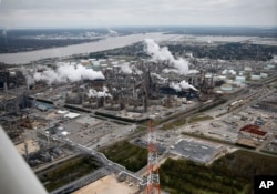FILE - In this aerial photograph about 10 miles upriver from New Orleans, the Shell Norco Manufaturing Complex, an oil refinery, is seen in St. Charles Parish, La., Jan. 10, 2016. The Mississippi River is above left, and the Bonnet Carre Spillway, which is used to divert river water to Lake Pontchartrain, is above right.