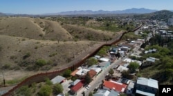 A photo made with a drone shows the U.S.-Mexico border fence cuts through the two downtowns of Nogales, April 2, 2017.
