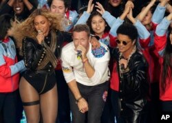 FILE - Beyonce, Coldplay singer Chris Martin, and Bruno Mars perform during halftime of the NFL Super Bowl game in Santa Clara, California, Feb. 7, 2016.