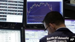 A specialist works at his post on the floor of the New York Stock Exchange, Tuesday, Aug. 9, 2011