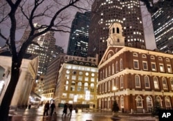 FILE - Faneuil Hall, right, is one of the sites on Boston's Freedom Trail. Rising seas around the world are putting such historic structures and coastal heritage sites under threat.