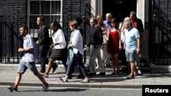 Victims of the Grenfell apartment tower block fire and volunteers leave 10 Downing Street after a meeting with Britain's Prime Minister Theresa May in London, June 17, 2017.