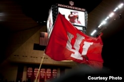 Indiana University cheerleaders wave an IU fan before a NCAA men's basketball game against Nebraska on Wednesday, Feb. 17, 2016, at Assembly Hall in Bloomington.