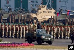 Pakistan's President Mamnoon Hussain, center on a military vehicle, reviews a military parade to mark Pakistan's Republic Day, in Islamabad, Pakistan, March 23, 2017.
