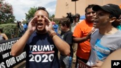 FILE - A man who called himself a citizen taxpayer, left, argues with protesters at a a rally to oppose a new Texas "sanctuary cities" bill that aligns with the president's tougher stance on illegal immigration, June 26, 2017, in San Antonio, outside of t