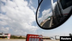 FILE - A truck is reflected in a rear-view mirror at Mexico-Puebla highway, on the outskirts of Mexico City, Mexico, March 8, 2018. 