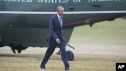 FILE - President Barack Obama crosses the White House South Lawn in Washington after arriving on Marine One helicopter from Andrew Air Force Base, Maryland, March 3, 2016.
