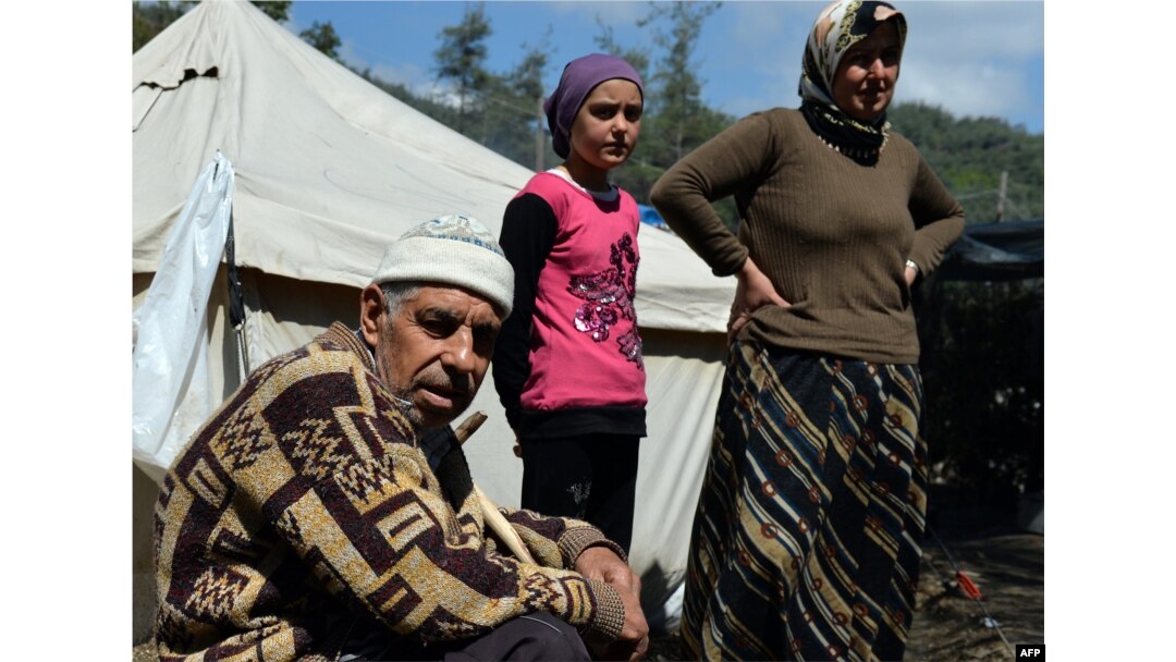 FILE - Syrian Turkmen are seen at a make-shift refugee camp some kilometers away from the Syria-Turkey border, Apr. 23, 2013.