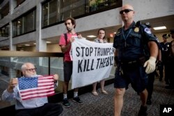 Capitol Hill police officers move in on a group protesting the Republican health care bill, on Capitol Hill in Washington, July 17, 2017.